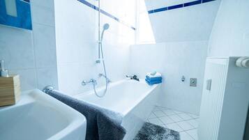 Shower, hair dryer, towels, toilet paper