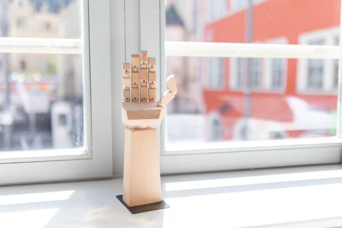 A wooden sculpture on a windowsill.