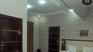A bedroom with a bed, a wardrobe, and a door. - Ambiance Hotel Baku (Baku)