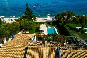 A rooftop with a swimming pool, a beach, and a lifeguard tower. - Barbati Beachfront Pool Villa (Barbati)