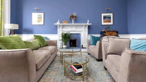 A living room with two sofas, a fireplace, and a coffee table.