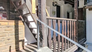 A wooden staircase with a metal railing leading to an upper floor. - Wonderful private villa for 4 people with patio and pets allowed (Someo)