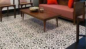 A room with a sofa, two chairs, a coffee table, and patterned flooring. - CREEK HARBOUR KOCHI  (Kochi)