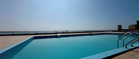 Outdoor pool, pool loungers, lifeguards on site