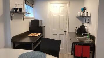 Fridge, microwave, coffee/tea maker, cookware/dishes/utensils
