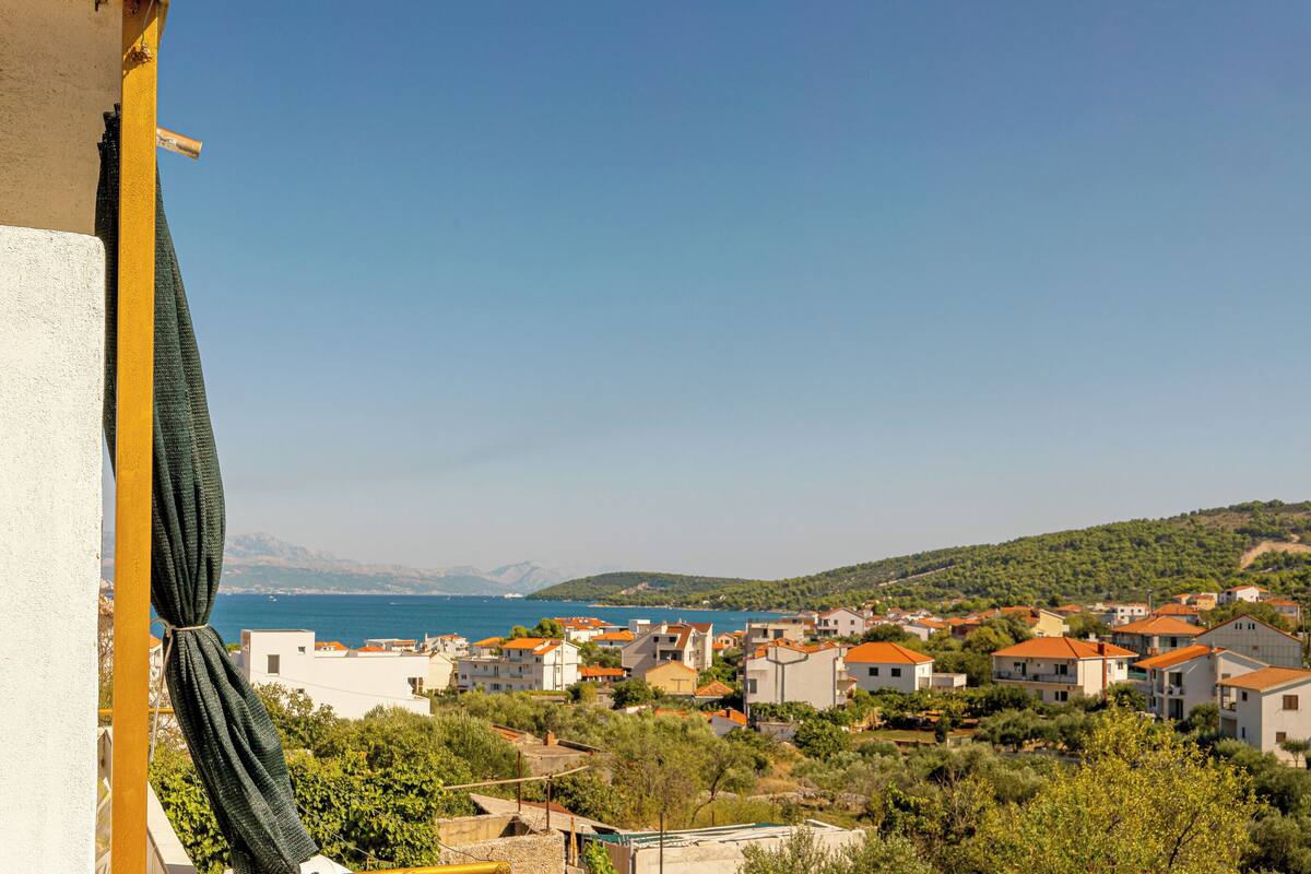 A coastal town with buildings and a clear view of the sea.