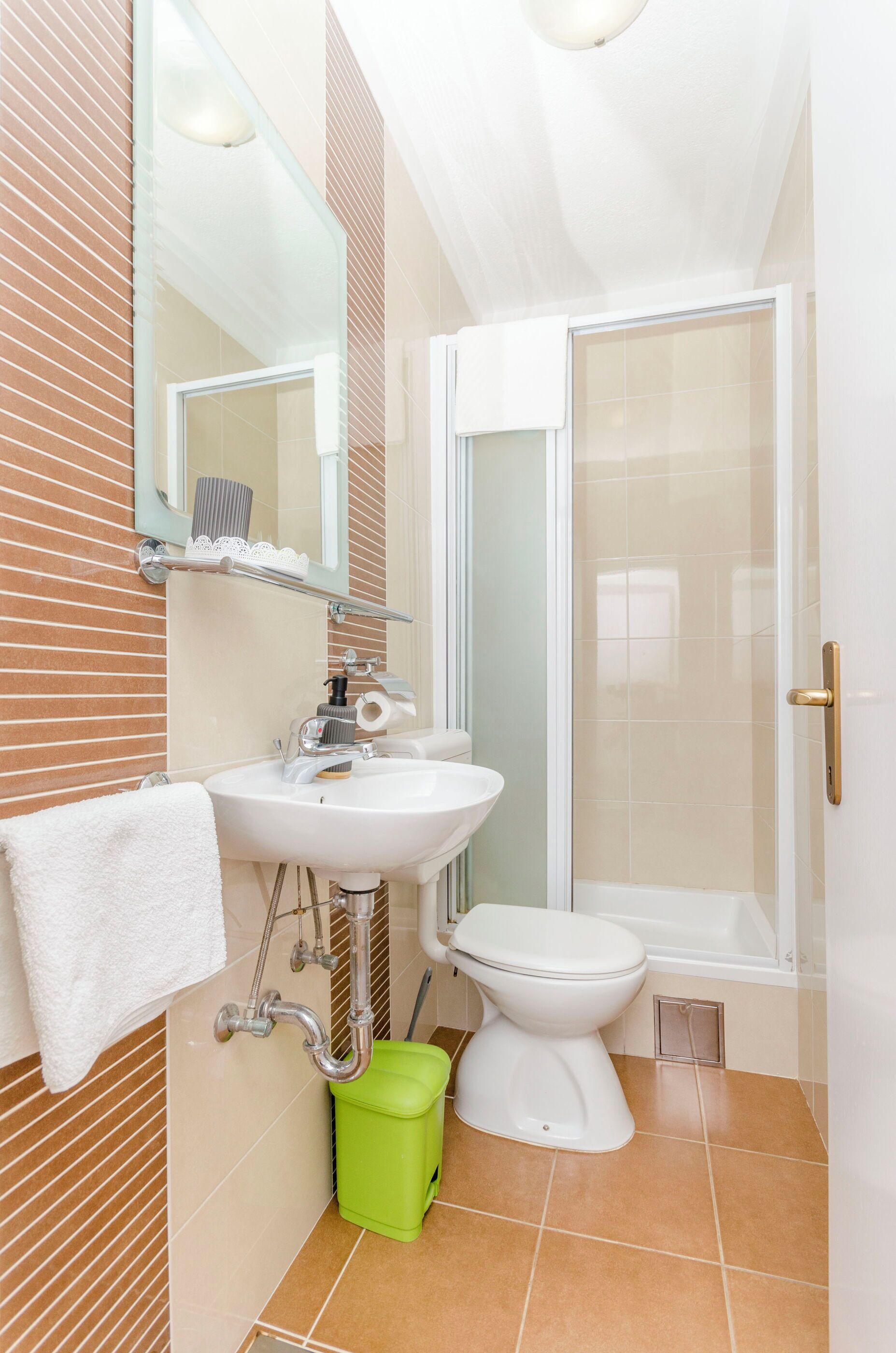 A bathroom with a sink, toilet, and shower.