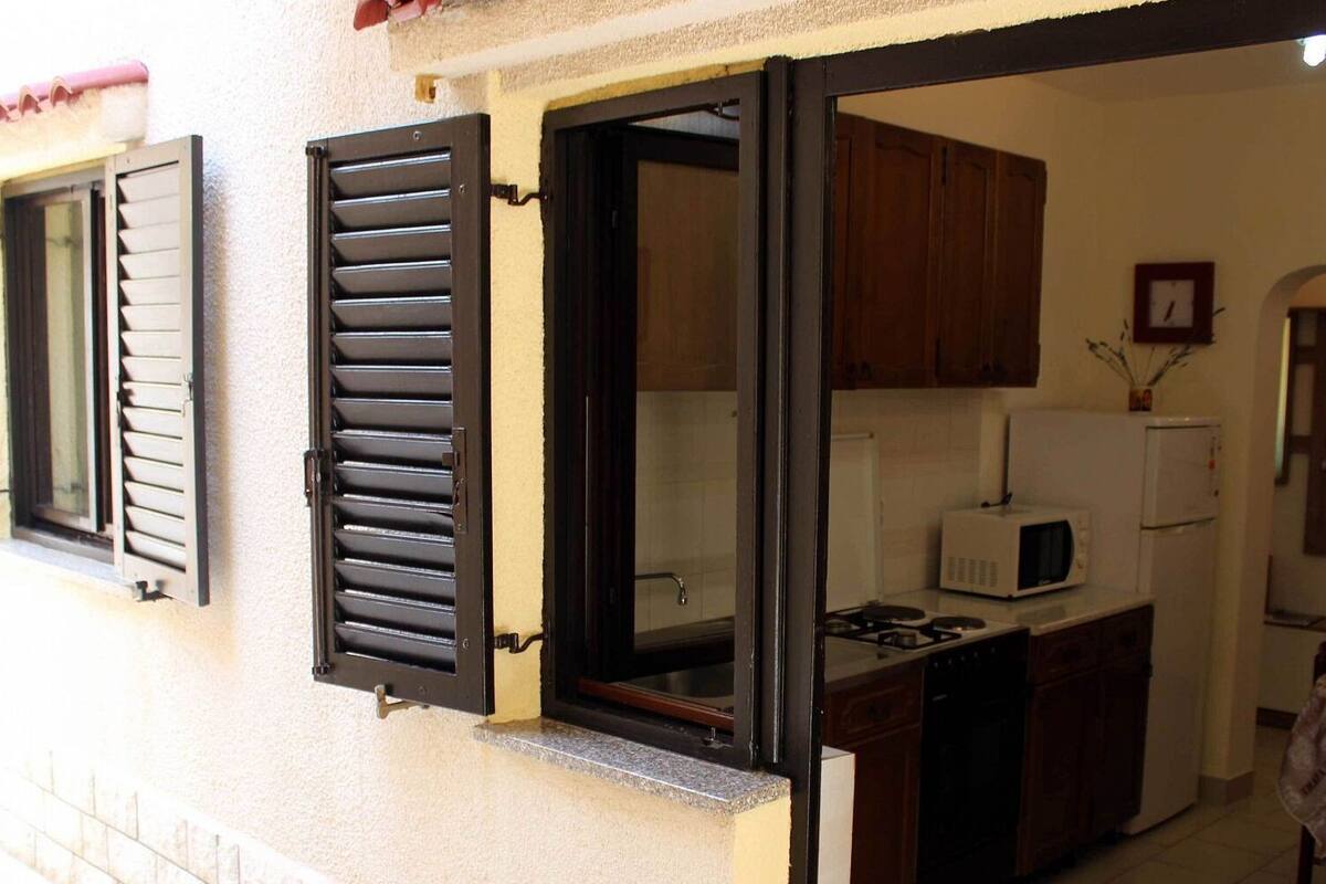 A kitchen with a stove, microwave, and cabinets.