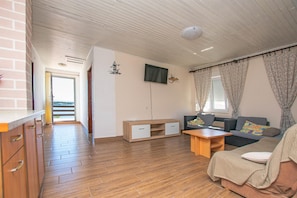 A modern living room with a sofa, a coffee table, and a wooden cabinet.