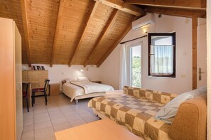 A bedroom with a bed, a sofa, a desk, and a chair. - Apartments Marija (Tisno)