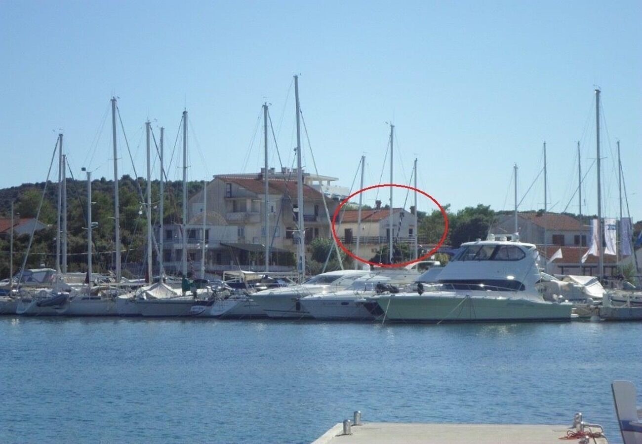 A marina with multiple yachts docked.