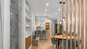 A modern interior with a dining area, kitchen, and a visible staircase. - Apartment 'Sky Costa Del Sol' with Shared Pool, Wi-Fi and Air Conditioning (Torremolinos)