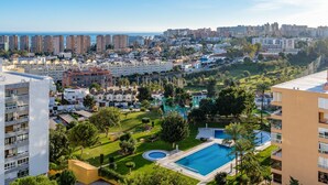 A residential area with a swimming pool, multiple apartment buildings, and a view of the sea. - Apartment 'Sky Costa Del Sol' with Shared Pool, Wi-Fi and Air Conditioning (Torremolinos)