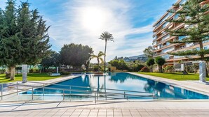A swimming pool with a clear view of a multi-story building in the background. - Apartment 'Sky Costa Del Sol' with Shared Pool, Wi-Fi and Air Conditioning (Torremolinos)