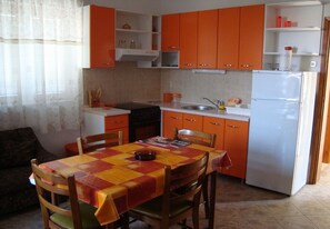 Apartment (A1) | Private kitchen | Fridge, microwave, oven, stovetop - Apartments Paulina (Postira)