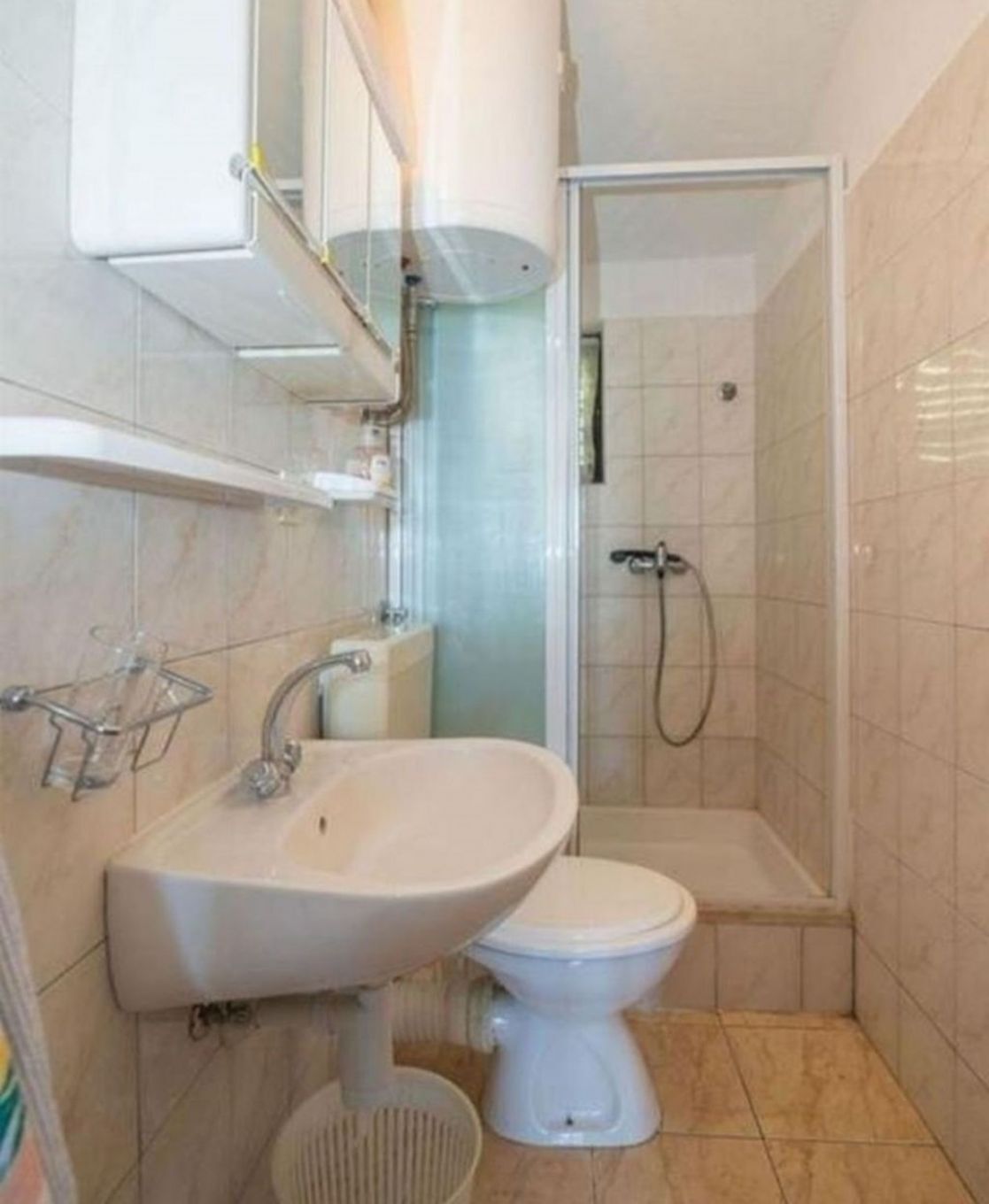 A bathroom with a sink, toilet, and shower.
