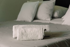 A neatly made bed with white linens and pillows. - Apartments Darko (Sukosan)