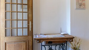 A wooden door with a frosted glass panel, a wooden desk with papers, a white keyboard, and a wall-mounted picture. - Apartment Vesna (Trogir)