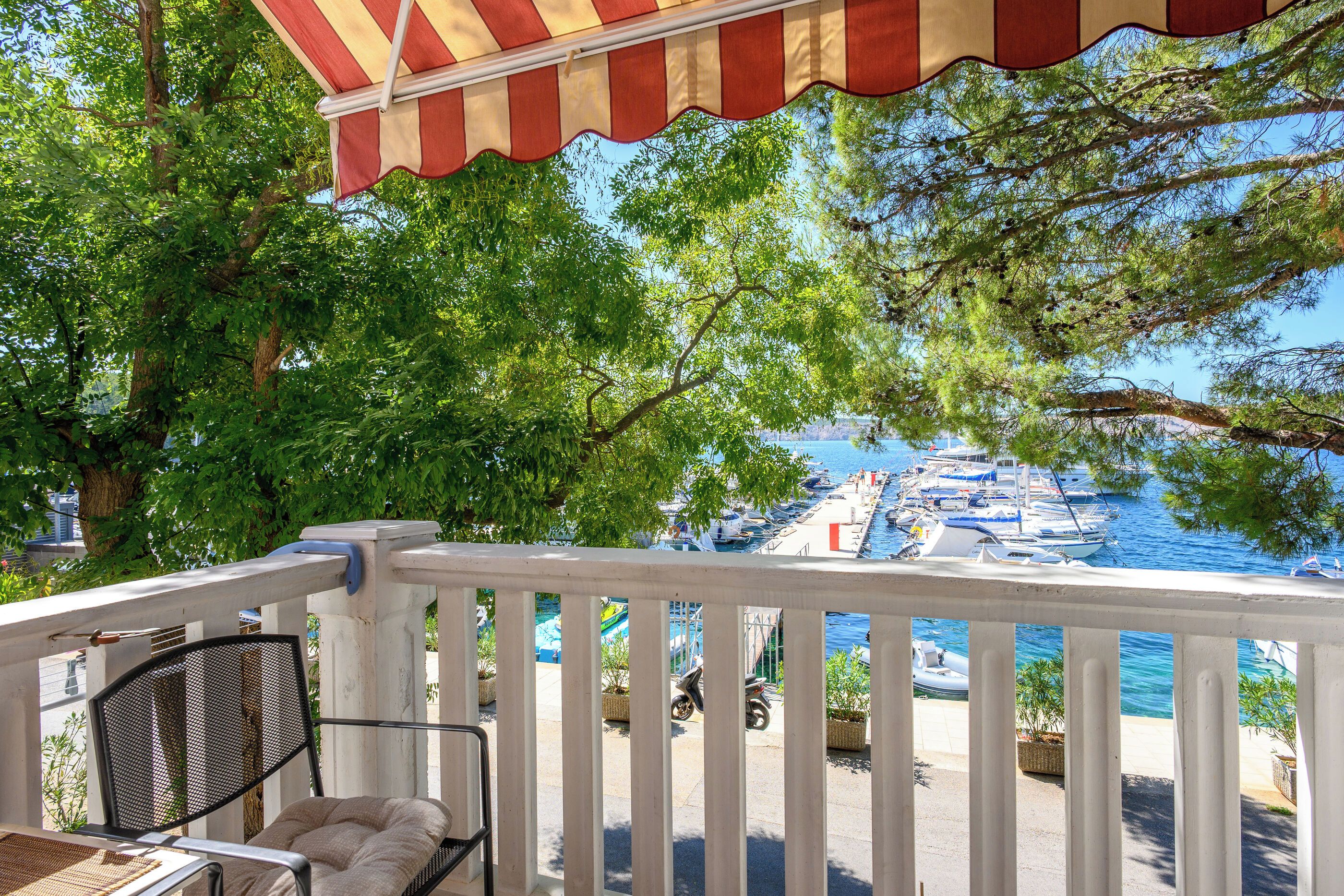 A balcony with a view of a marina and boats.