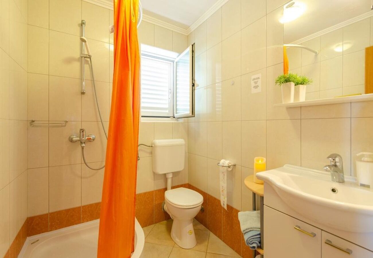 A bathroom with a bathtub, toilet, shower, and sink.
