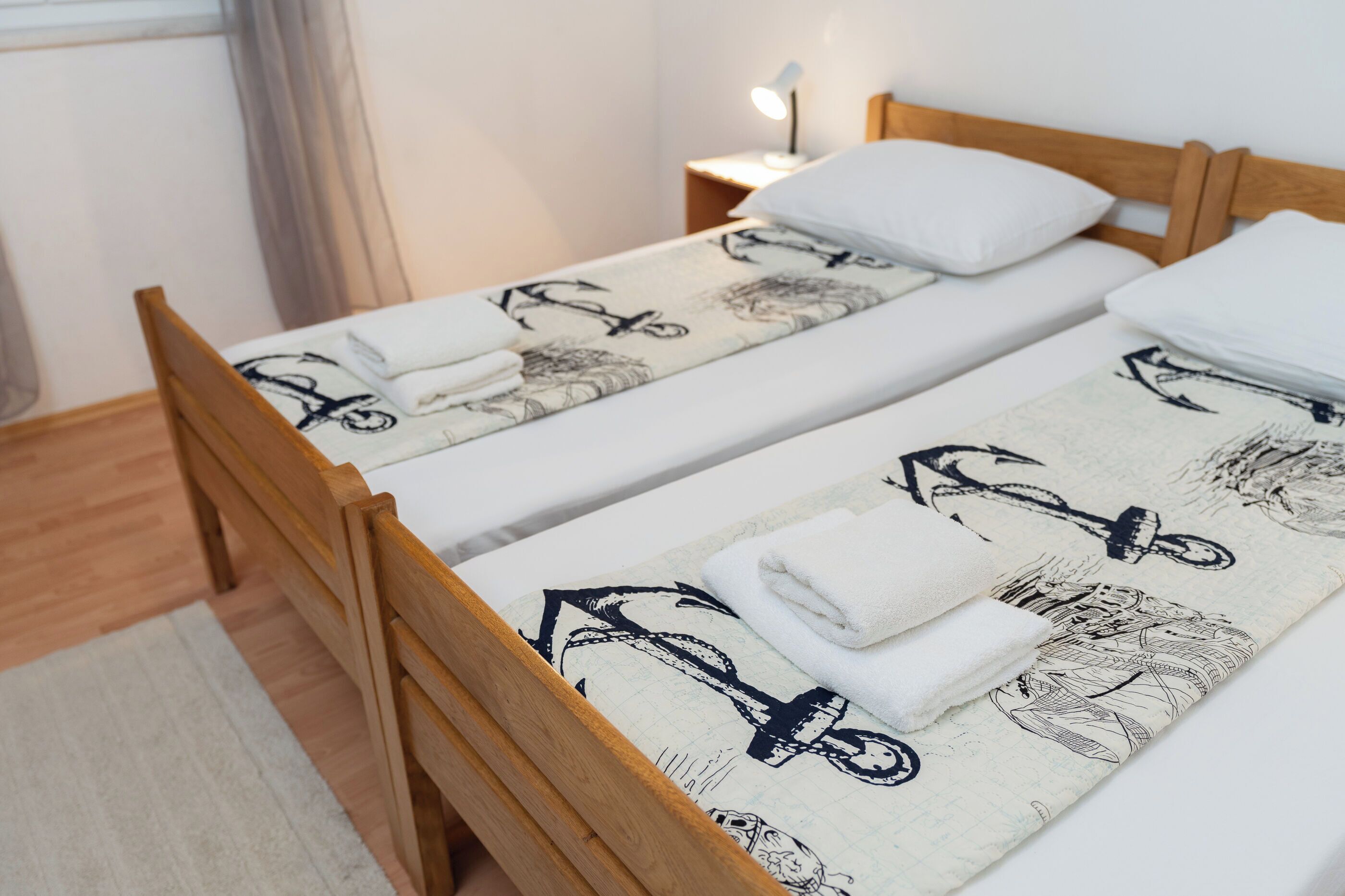 A double bed with a patterned bedspread and two pillows.