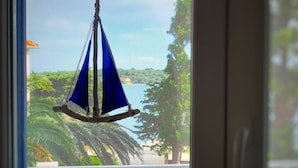 A view through a window with a sail hanging in the foreground. - Apartment Goran (Sali)