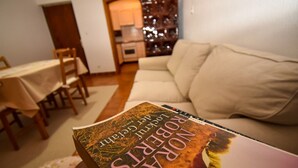 A book titled 'Nora's Journey' on a table in a living room with a sofa and a dining area in the background. - Apartments and Rooms Frane (Rab)