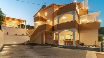 Un edificio de varios pisos con un patio central, una escalera que conduce a los niveles superiores y una recepción con mostrador.
