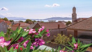 A coastal town with traditional architecture, a prominent church tower, and a view of the sea. - Apartments Slavko With Terrace (Kastela)