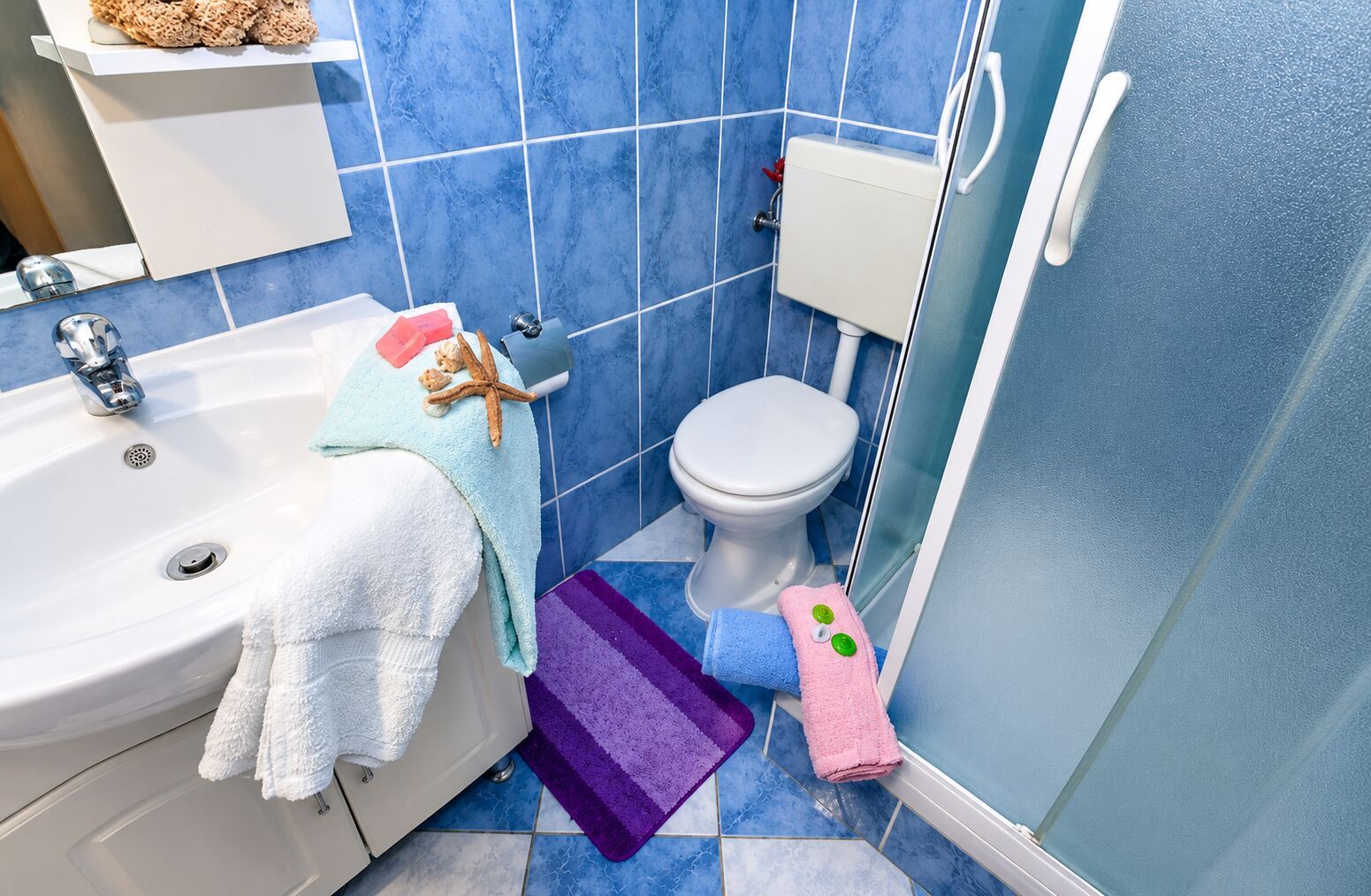 A bathroom with a bathtub, toilet, and sink.