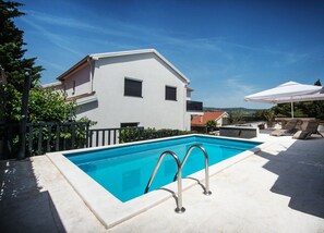 A modern two-story house with a swimming pool, outdoor seating, and a clear view of the surrounding landscape. - House Nepi (Rogoznica)