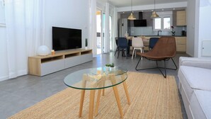 A modern living room with a glass table, a flat-screen TV, and a sofa. - House Kreso (Sibenik)