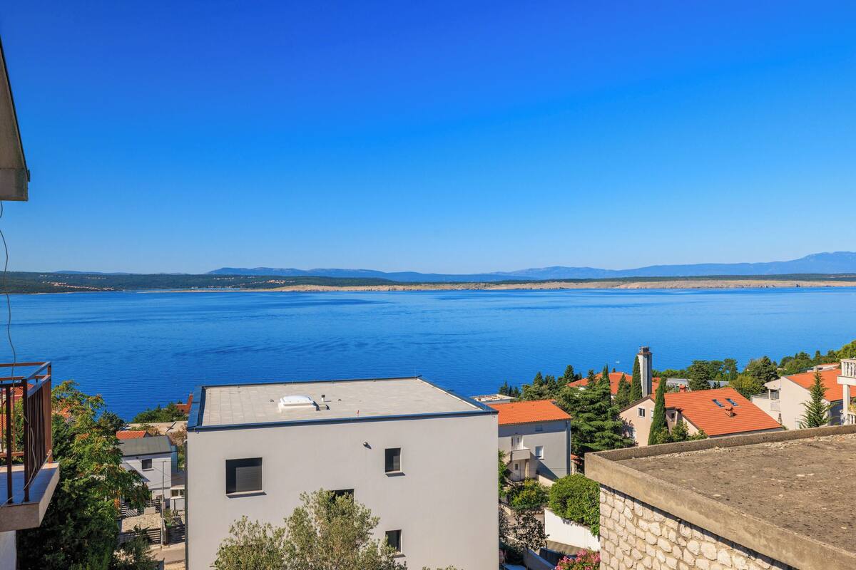 A coastal view with buildings and a large body of water.