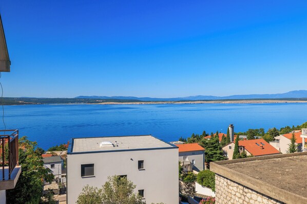 A coastal view with buildings and a large body of water. - Apartments Olgi (Crikvenica)