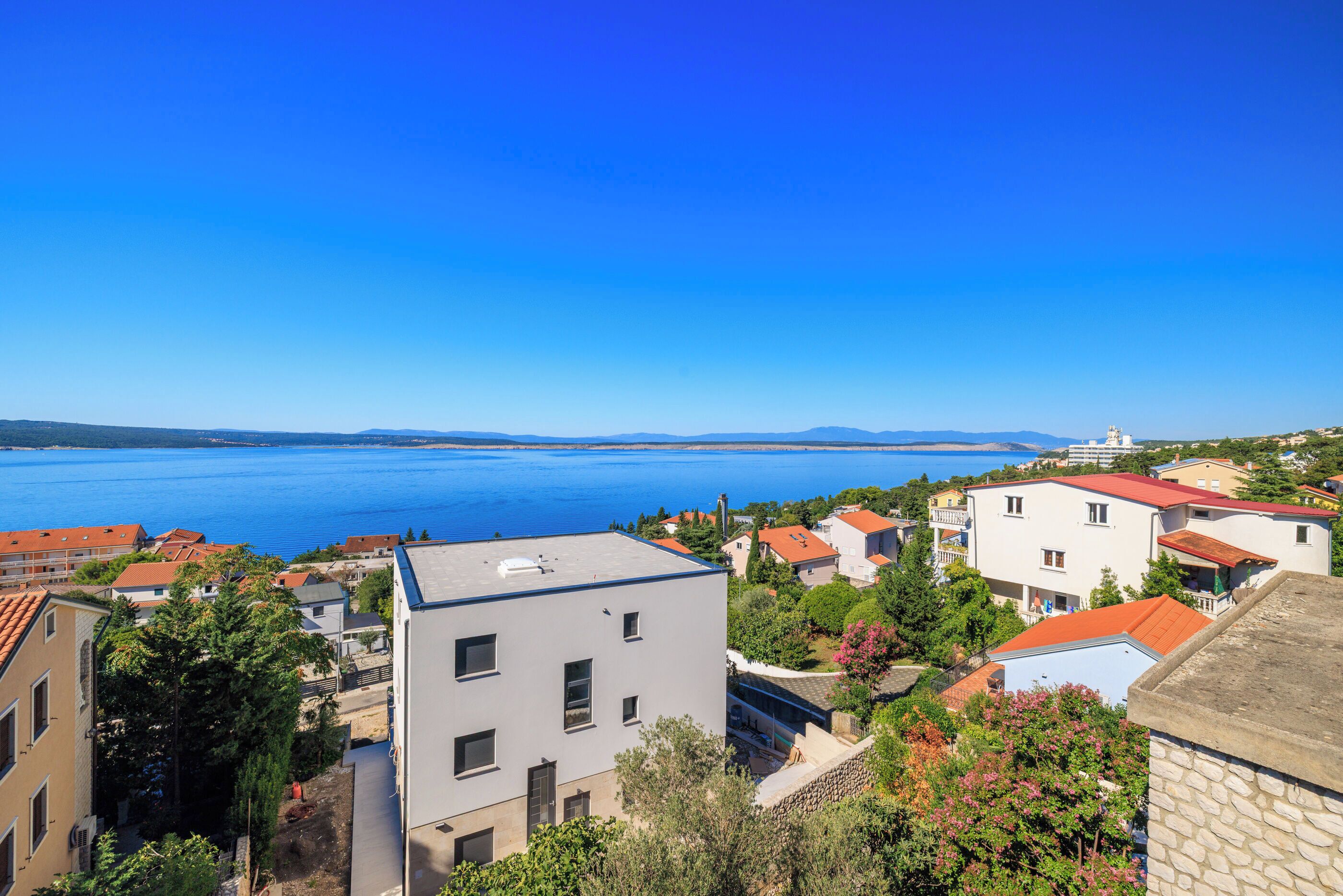 A coastal town with buildings and a clear view of the sea.