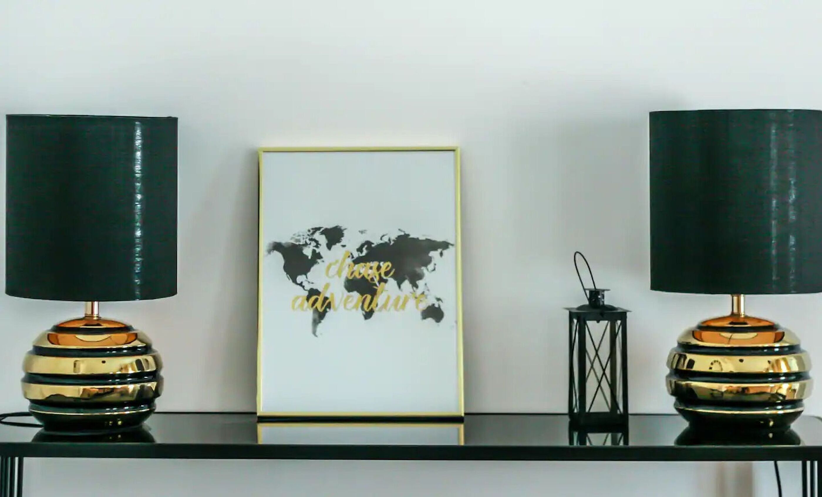 A framed world map with the text "choose adventure" on a wall.