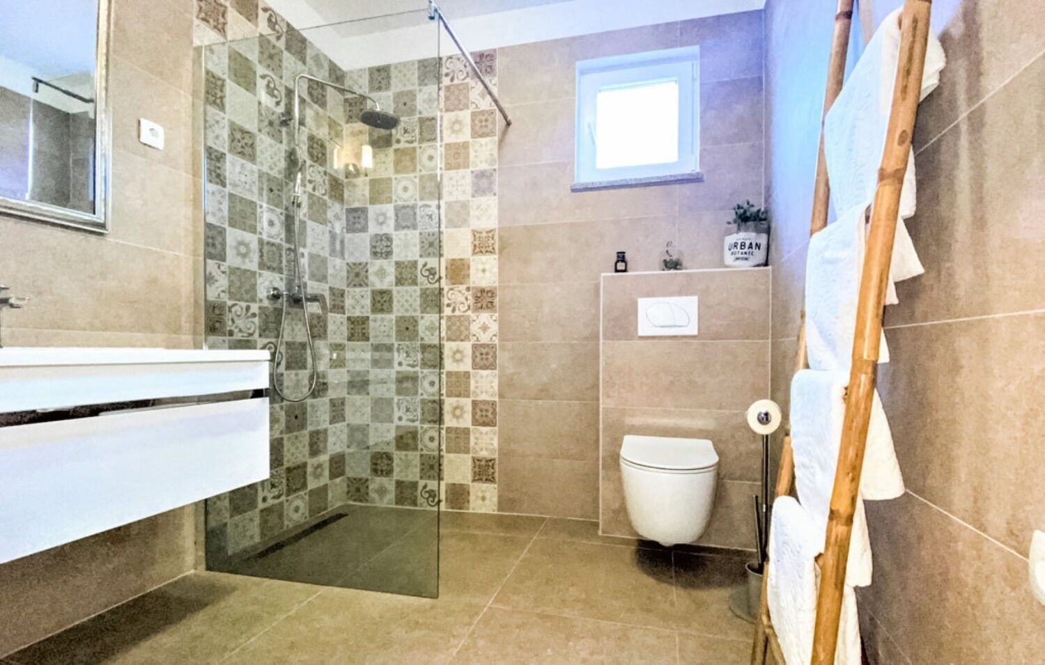 A bathroom with a shower, toilet, and sink.