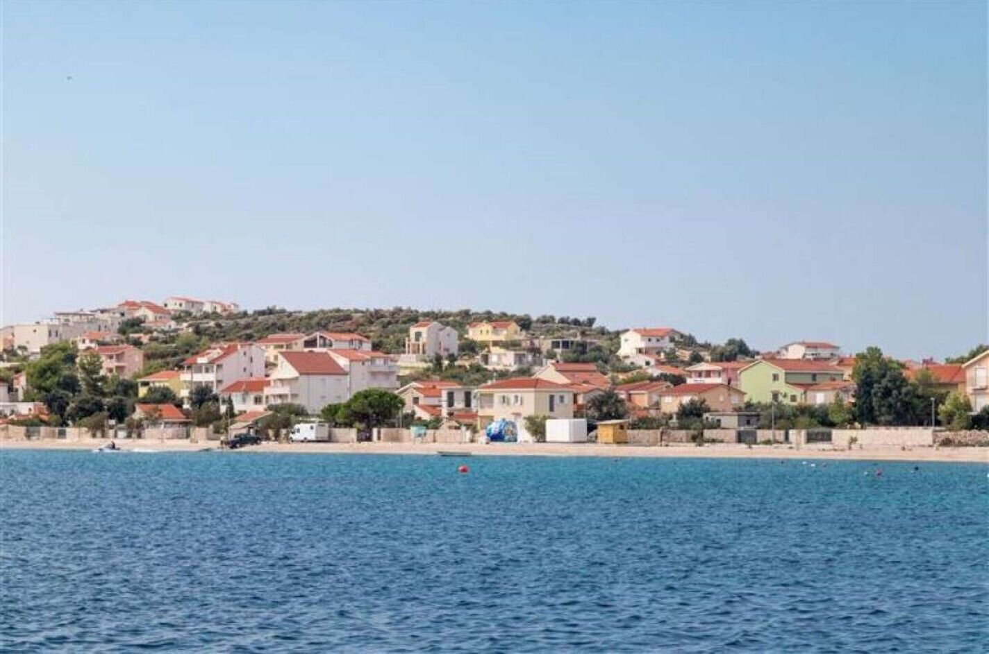 A coastal town with buildings along the shoreline.