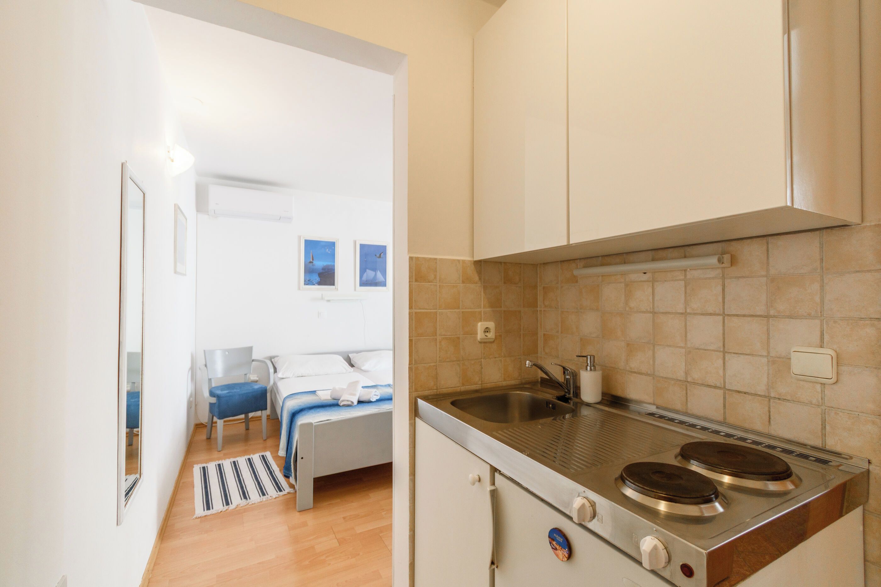 A compact kitchen with a gas stove, a sink, and a small countertop.