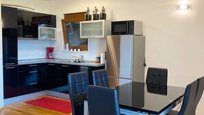 A modern kitchen with a dining area. - House DMS (Tisno)
