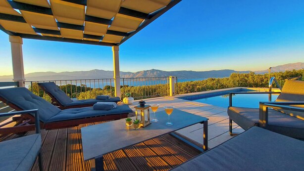 A rooftop terrace with a pool, lounge chairs, and a table with drinks. - House Fani (Postira)