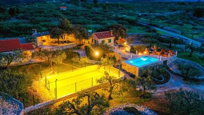 A villa with a swimming pool, stone walls, and a view of the surrounding landscape. - House Fani (Postira)