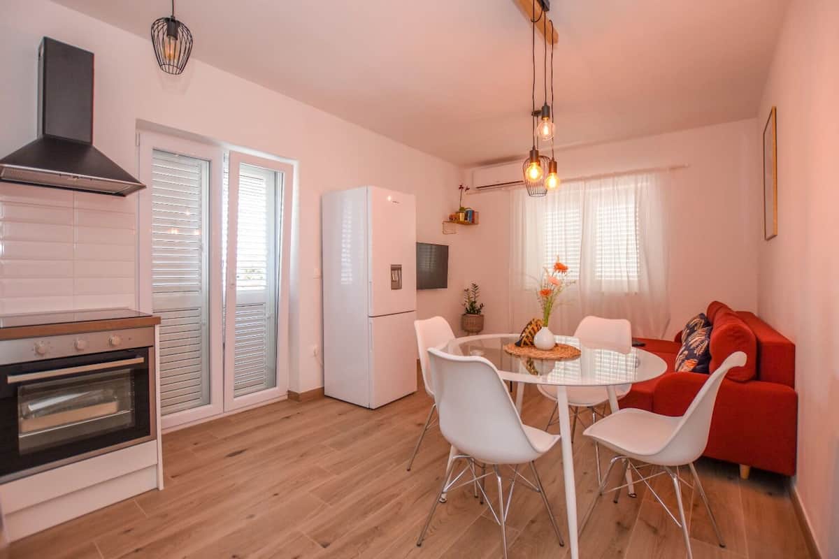 A compact living space with a kitchen, dining area, and seating area.