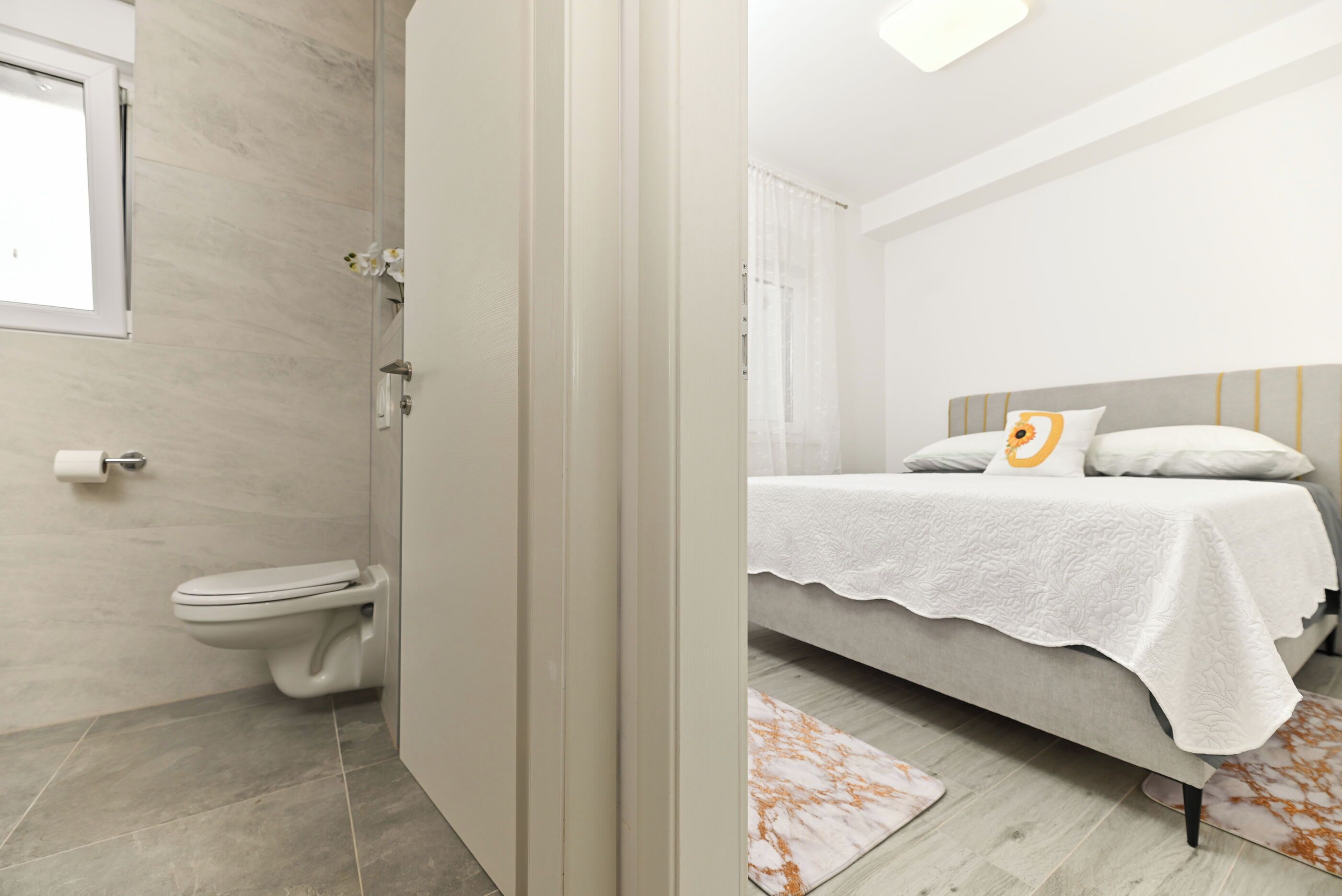 A modern bedroom with a bed, a bedside table, and a nightstand.