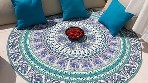 A round, patterned rug with a bowl of strawberries on a patio. - House Matenda House (Solin)