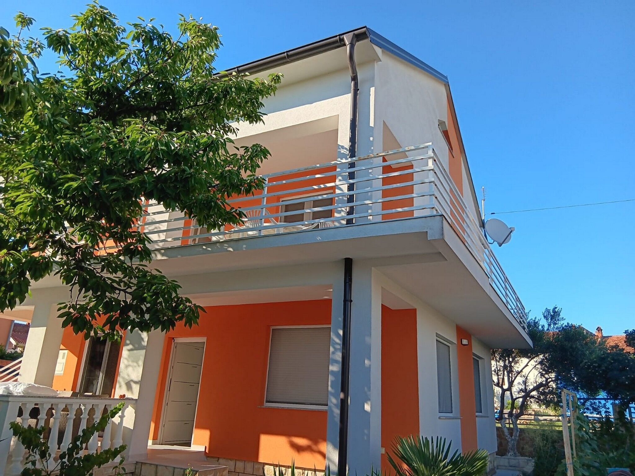A two-story building with a balcony on the upper floor.