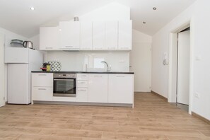 Apartment (A4) | Private kitchen | Fridge, oven, stovetop, electric kettle - Apartments Pavlovic (Vodice)