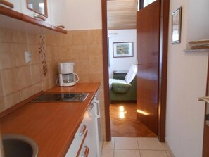 Apartamento (A3) | Cozinha privada | Geladeira, cooktop, talheres/pratos/utensílios de cozinha, freezer