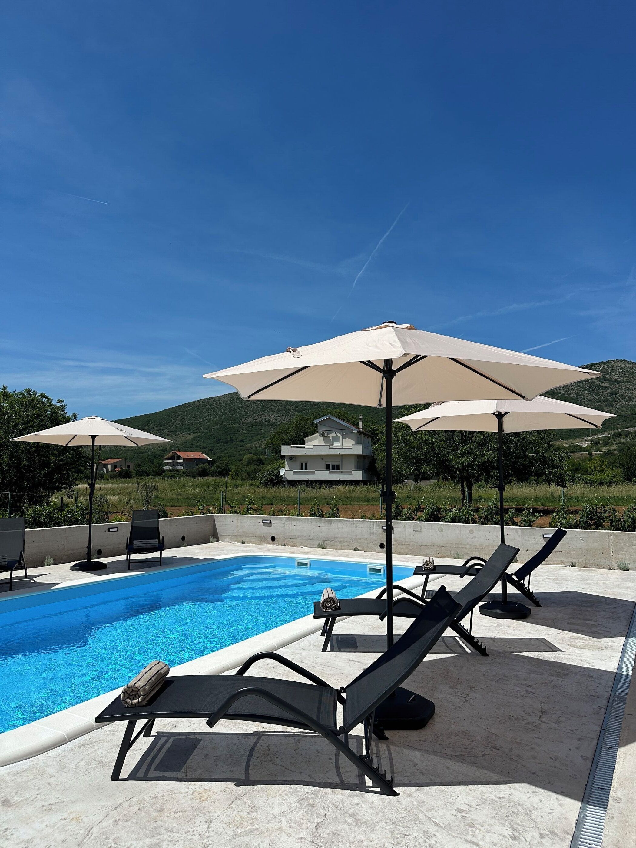 Outdoor pool, pool umbrellas, pool loungers