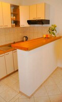 Apartment (A1) | Private kitchen | Fridge, stovetop, cookware/dishes/utensils, freezer